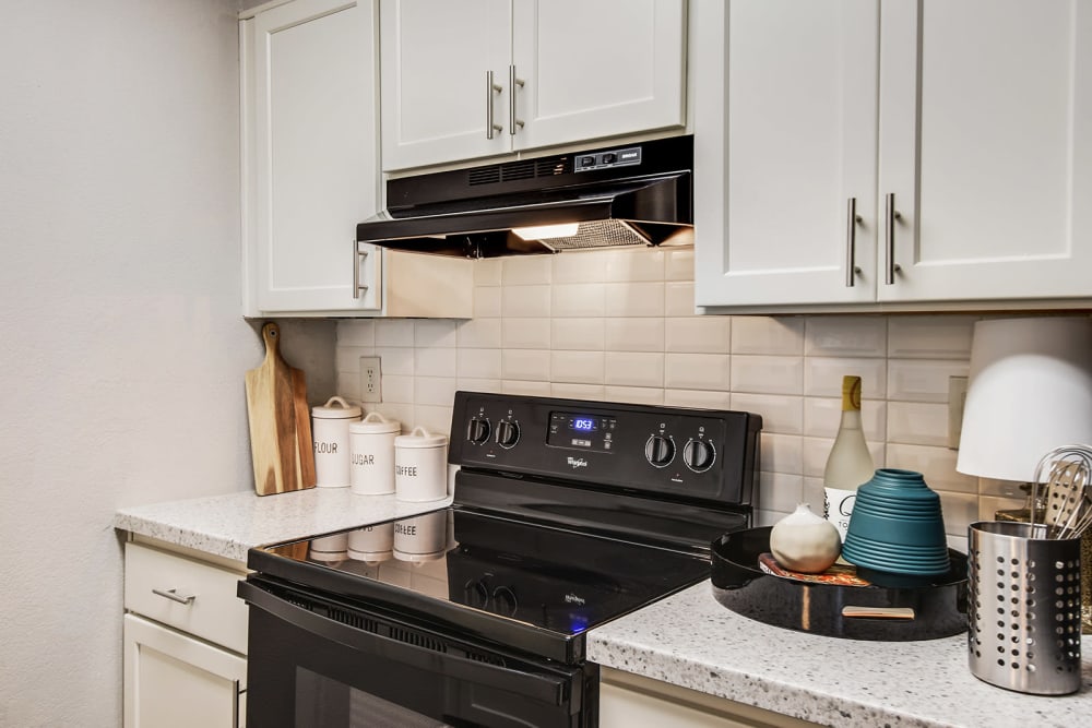 Kitchen with black appliances at The Alcove in Smyrna, Georgia