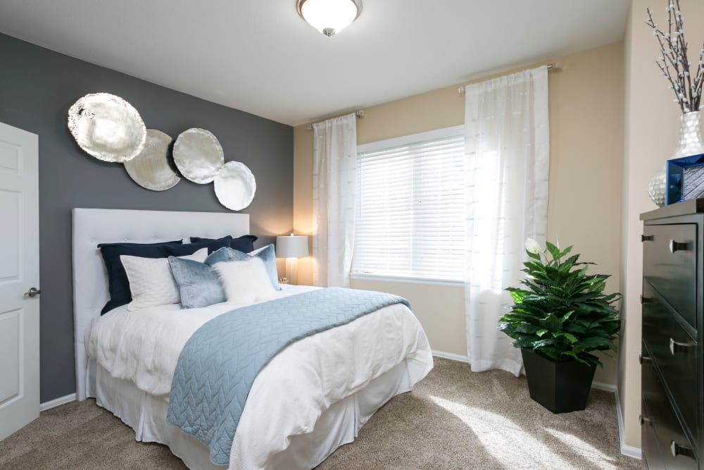 A bright bedroom at Crestone Apartments in Aurora, Colorado
