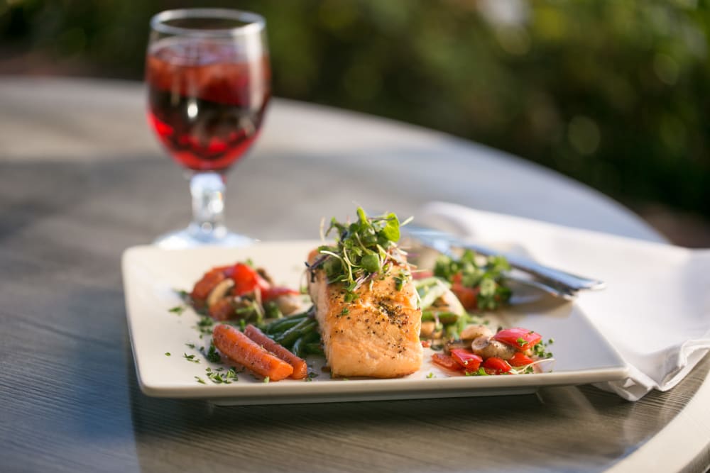 Dinner dish of Salmon and drink at the Meridian at Ocean Villa