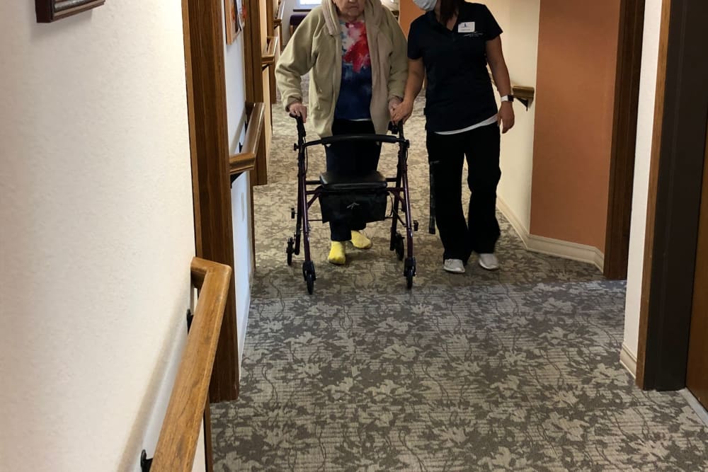 Staff provides walking assistance to resident at Landings of Sauk Rapids in Sauk Rapids, Minnesota