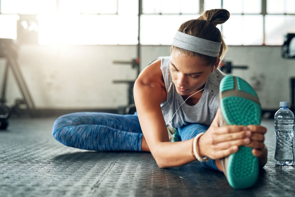Resident stretching at her community gym at Alvadora Apartments in Lawrence, Kansas