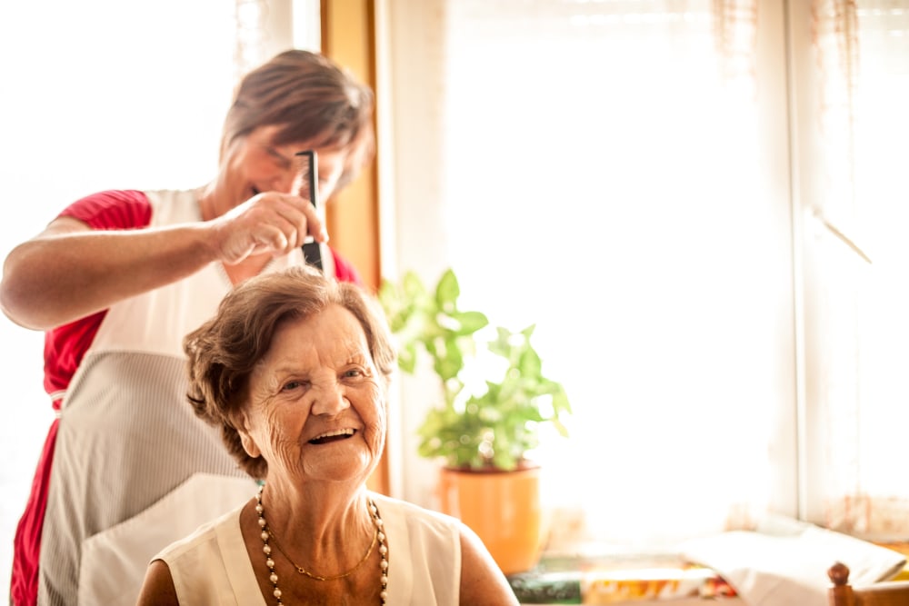 A resident gets her hair done near at Arlington Place of Grundy Center in Grundy Center, Iowa