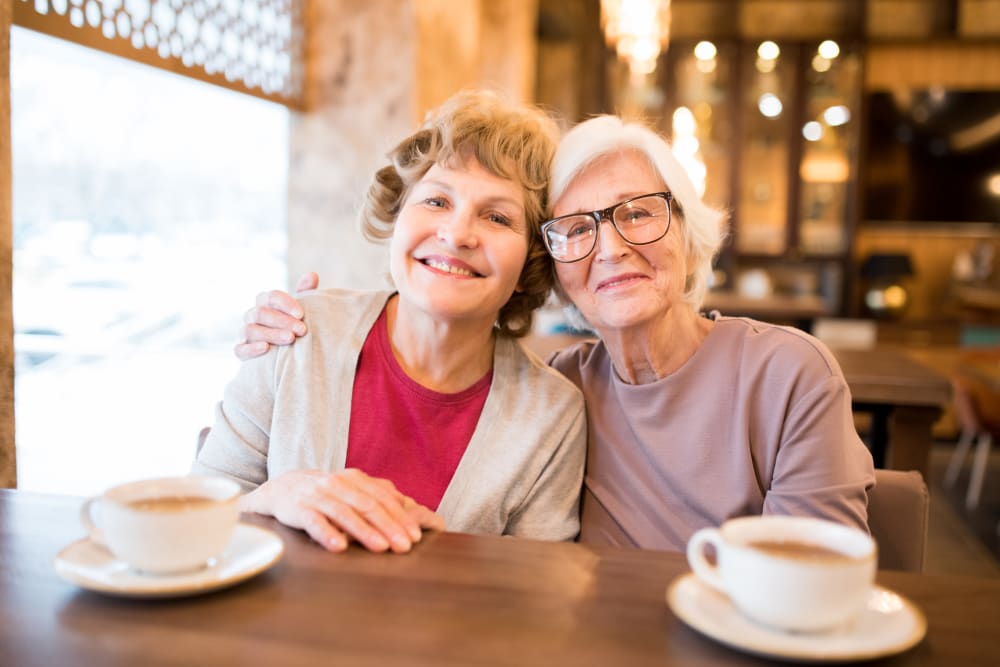 Two residents sitting together over coffee at Arlington Place of Grundy Center in Grundy Center, Iowa
