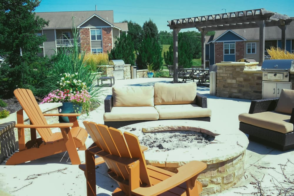 Outdoor fireplace with seating at Aberdeen Apartments in Lawrence, Kansas
