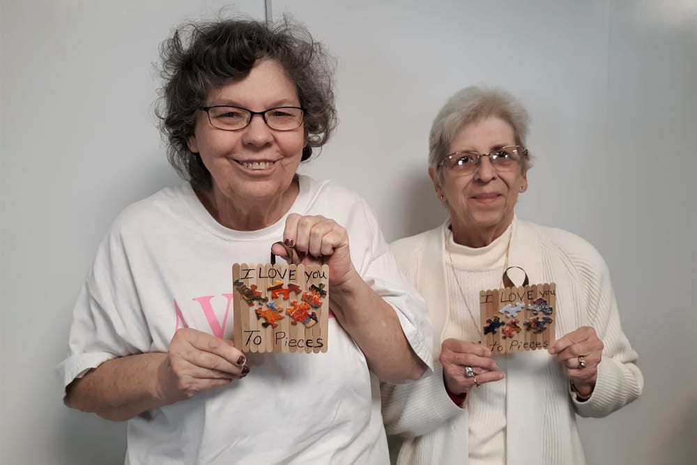 Two residents show their arts and craft project at Corridor Crossing Place in Cedar Rapids, Iowa