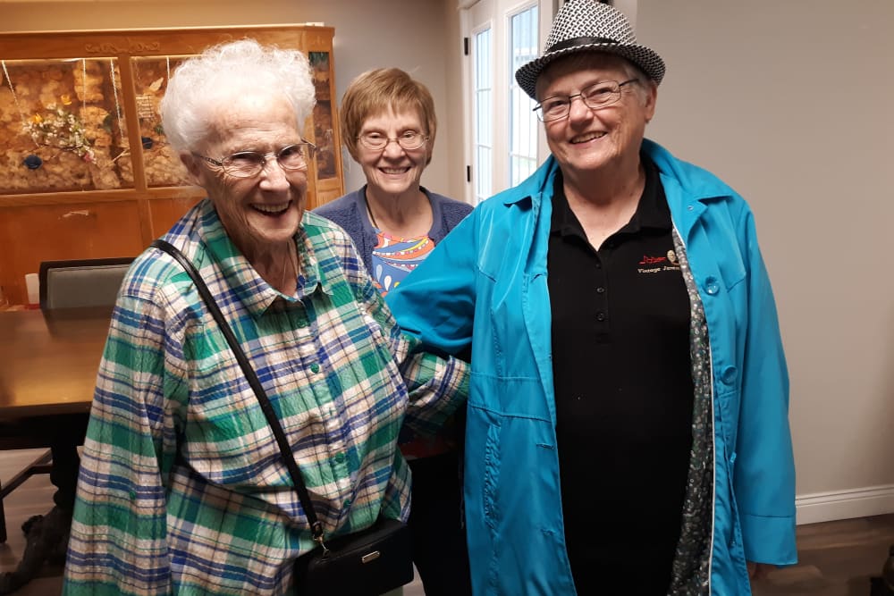 Three residents pose for the camera at Corridor Crossing Place in Cedar Rapids, Iowa
