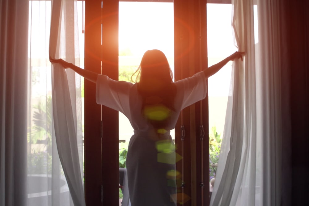 Resident stepping on to her balcony at San Artes in Scottsdale, Arizona