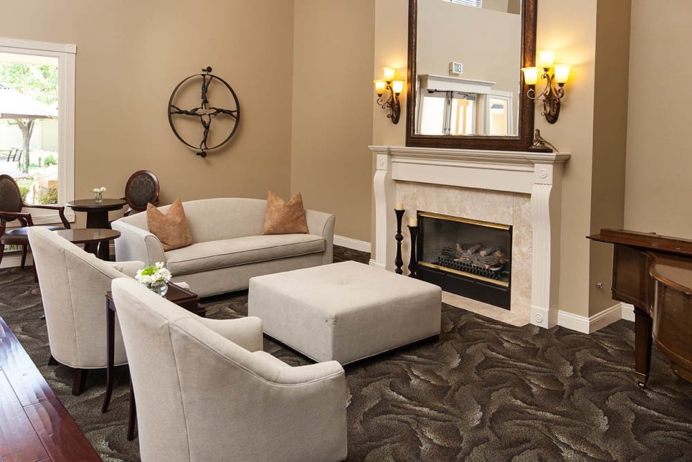 Quaint lounge with fireplace at Claremont Place in Claremont, California