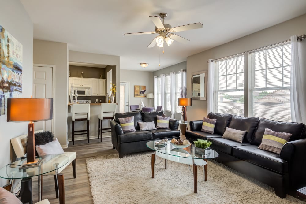 A spacious and open living room with large windows at Alvadora Apartments in Lawrence, Kansas