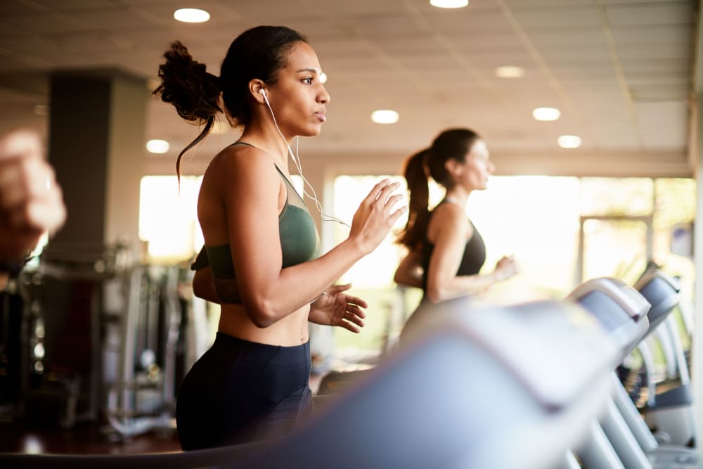 Woman running on treadmill at Square 50 Apartments in Washington, District of Columbia