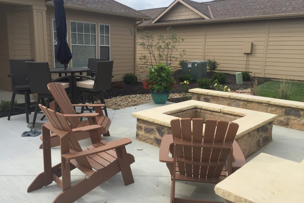Firepit surrounded by comfortable seating on a nice summer night at Alvadora Apartments in Lawrence, Kansas