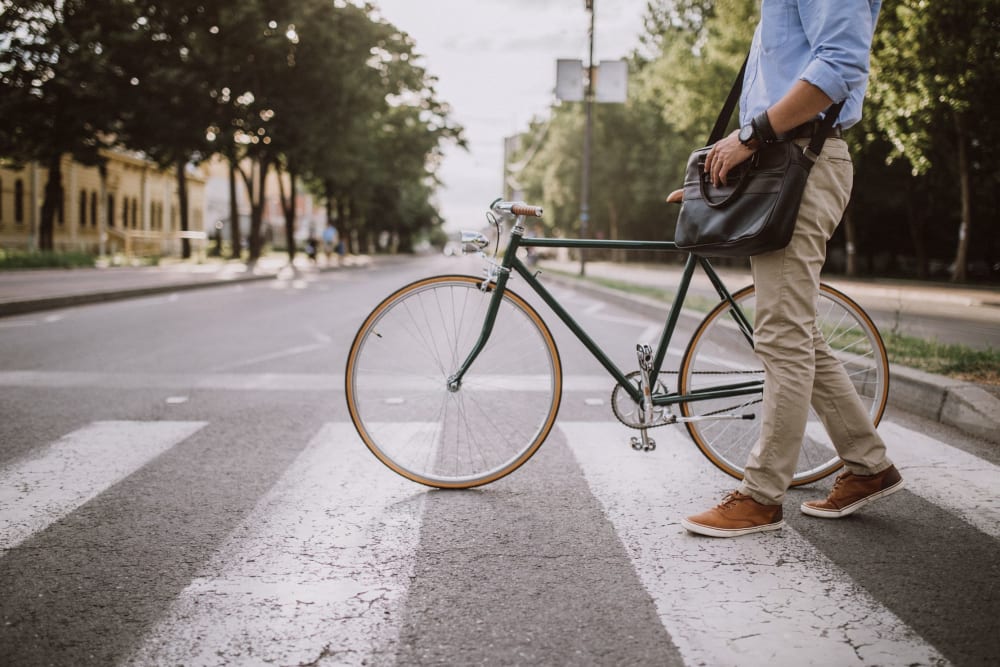 Resident crossing the street with his bike near 17th Street Lofts in Atlanta, Georgia