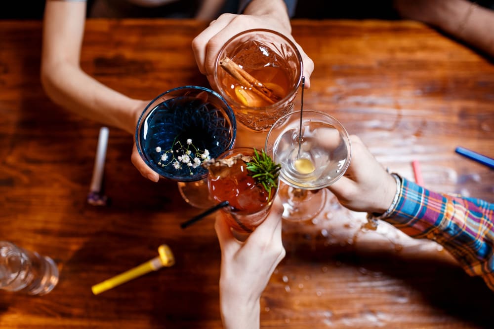 Friends sharing drinks at a local bar in Atlanta, Georgia near 17th Street Lofts