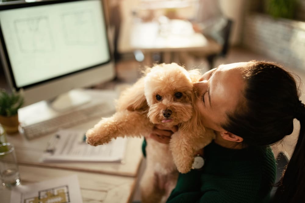 Resident hugging her dog at 17th Street Lofts in Atlanta, Georgia
