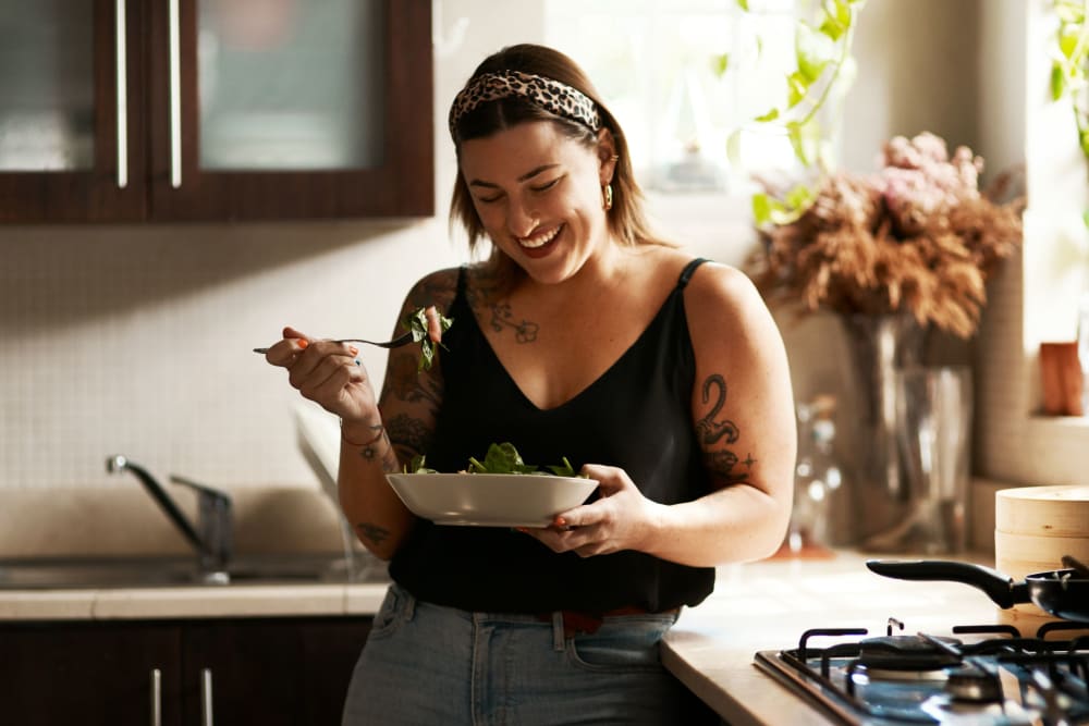 Resident eating lunch in her kitchen at 17th Street Lofts in Atlanta, Georgia