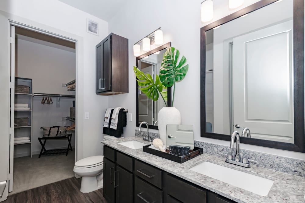 Well decorated bathroom with a walk-in closet at Magnolia on the Green in Allen, Texas