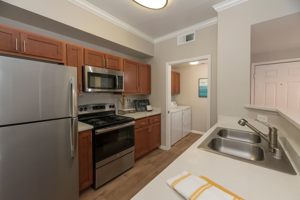 Kitchen with wood-style flooring and stainless steel appliances at Avion Apartments in Rancho Cordova, California