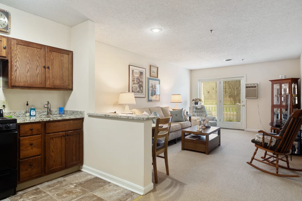 Kitchen and living room are in a 1 bedroom apartment at The Hearth at Castle Gardens in Vestal, New York