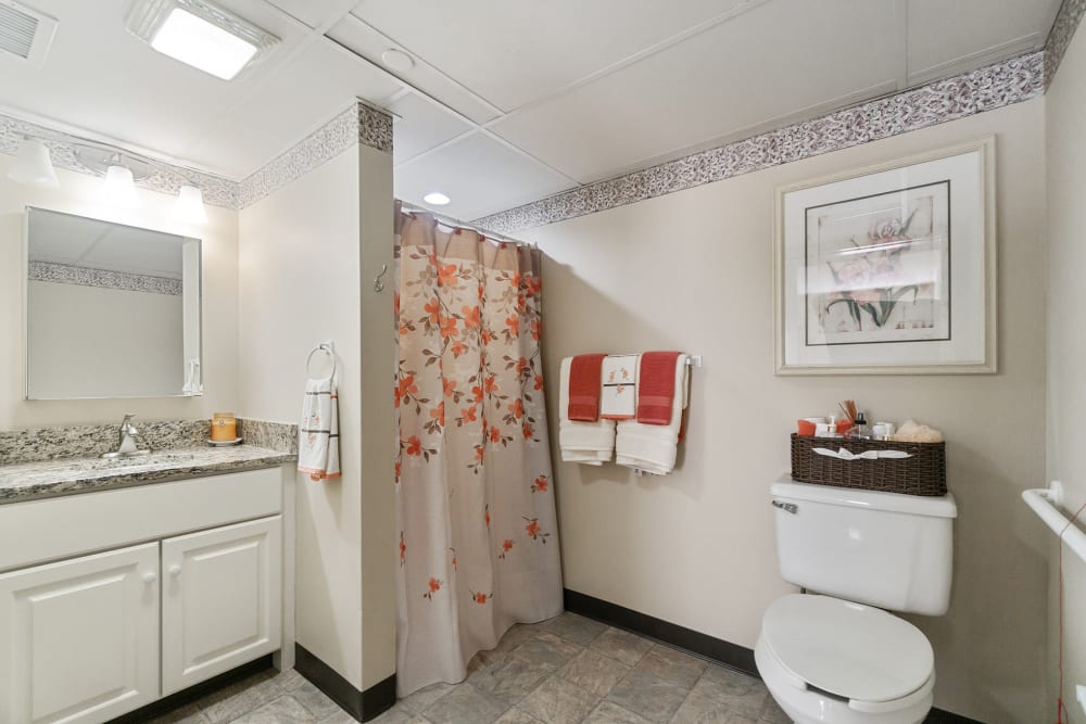 Senior apartment bathroom with a walk in shower at The Hearth at Gardenside in Branford, Connecticut