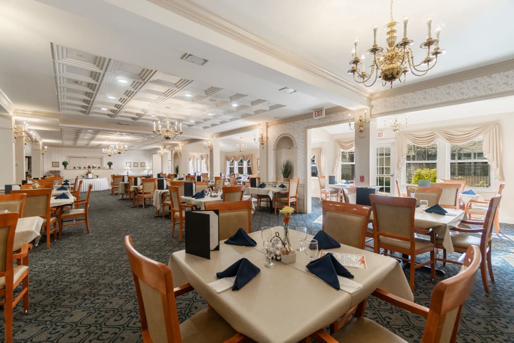 Long dining hall with spaced out tables and bright lighting at The Hearth at Gardenside in Branford, Connecticut