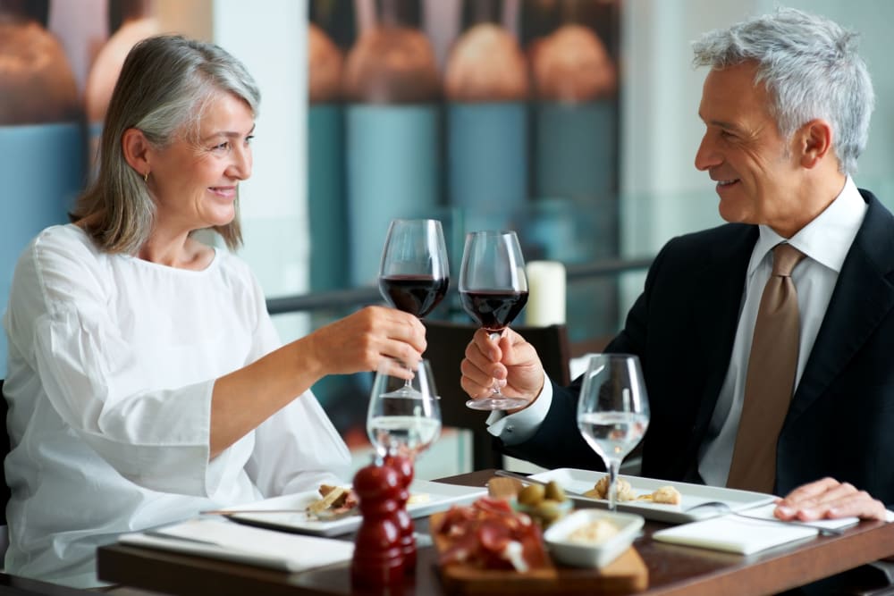 Residents enjoying wine at a local restaurant in Sacramento, California near Campus Commons Senior Living