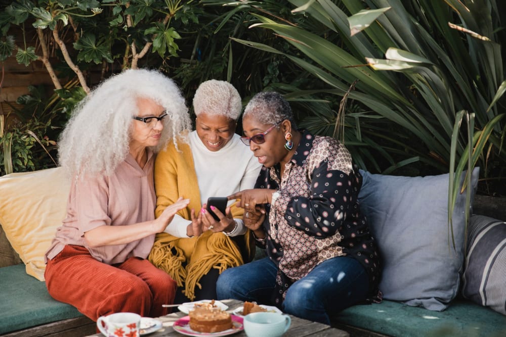 Friends chatting over brunch at Campus Commons Senior Living in Sacramento, California