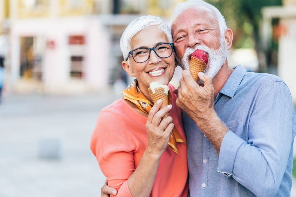 Happy couple eating ice cream together near Campus Commons Senior Living in Sacramento, California