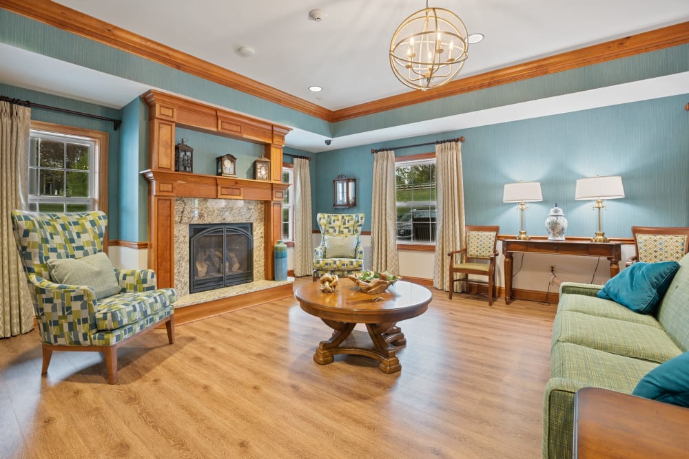 Lounge area with hardwood floors and a fireplace at The Hearth at Hendersonville in Hendersonville, Tennessee