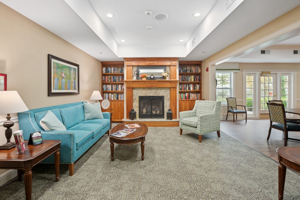 Carpeted area of a lounge with a fireplace at The Hearth at Hendersonville in Hendersonville, Tennessee
