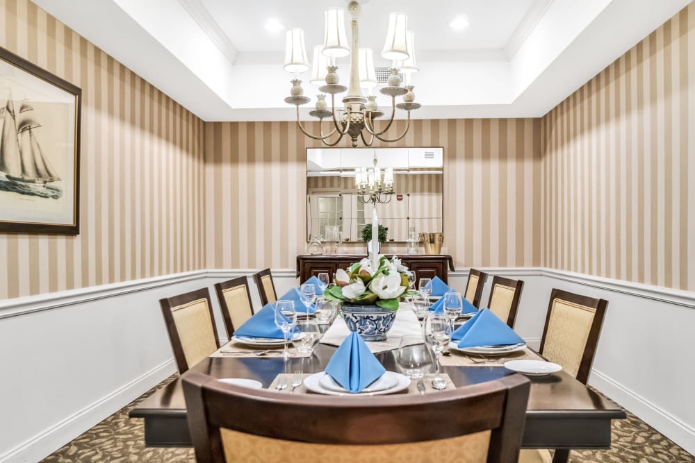 Private family dining room with a long dark wood table in The Hearth at Tuxis Pond in Madison, Connecticut