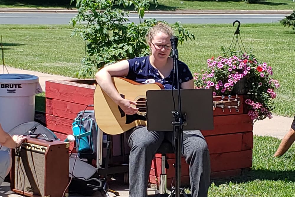 A woman plays the guitar at Landings of Blaine in Blaine, Minnesota