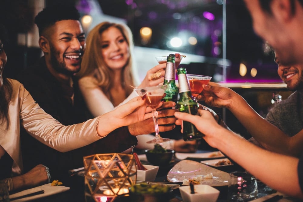 Friends enjoying drinks together near Solace on Peachtree in Atlanta, Georgia