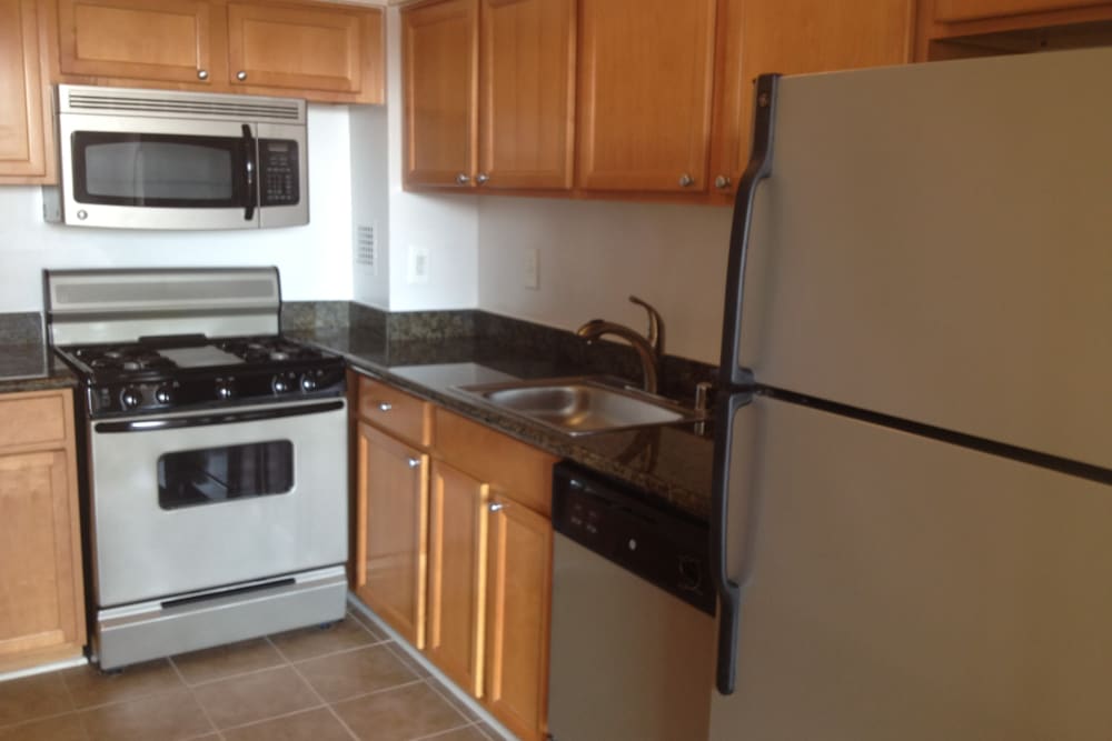 A kitchen with stainless-steel appliances at 770 C Street Apartments in Washington, District of Columbia