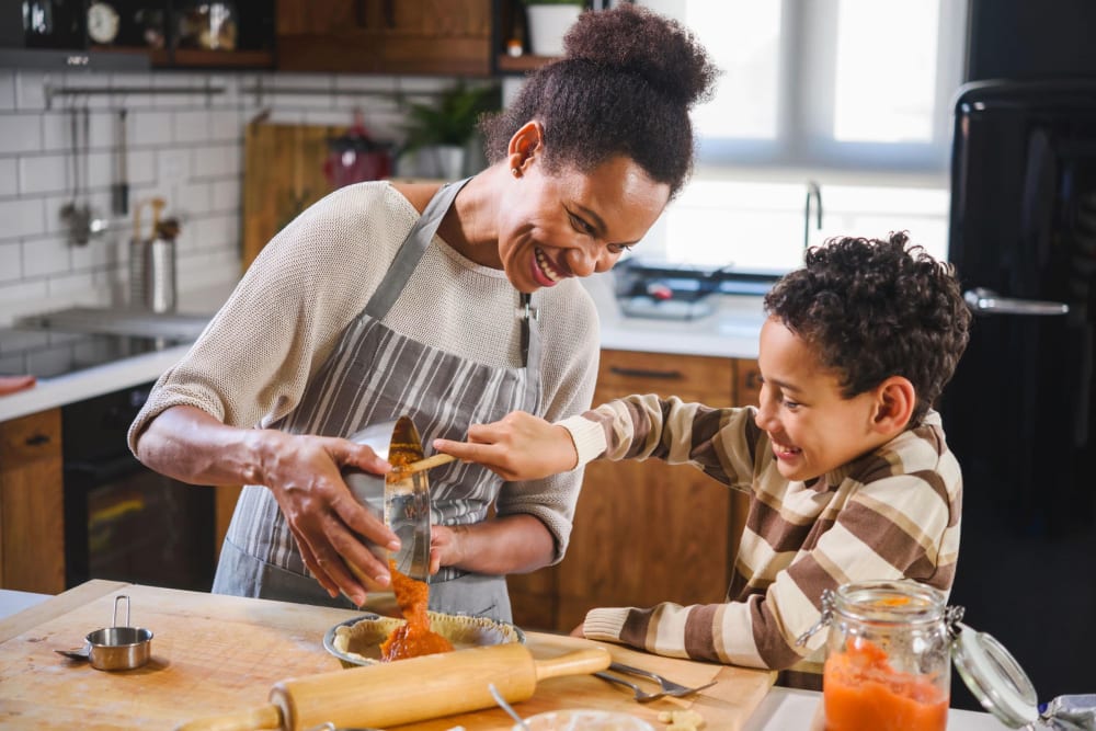 Resident cooking with her child at Lakeview Residences in Aurora, Illinois