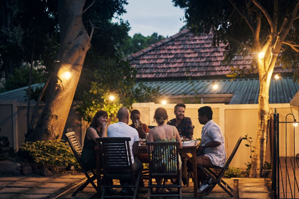 Friends enjoying dinner outside at Loring Park Apartments in Minneapolis, Minnesota