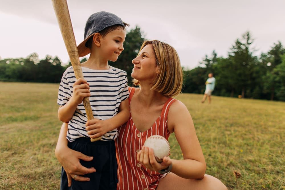 Mother and son playing baseball in Minneapolis, Minnesota near Loring Park Apartments