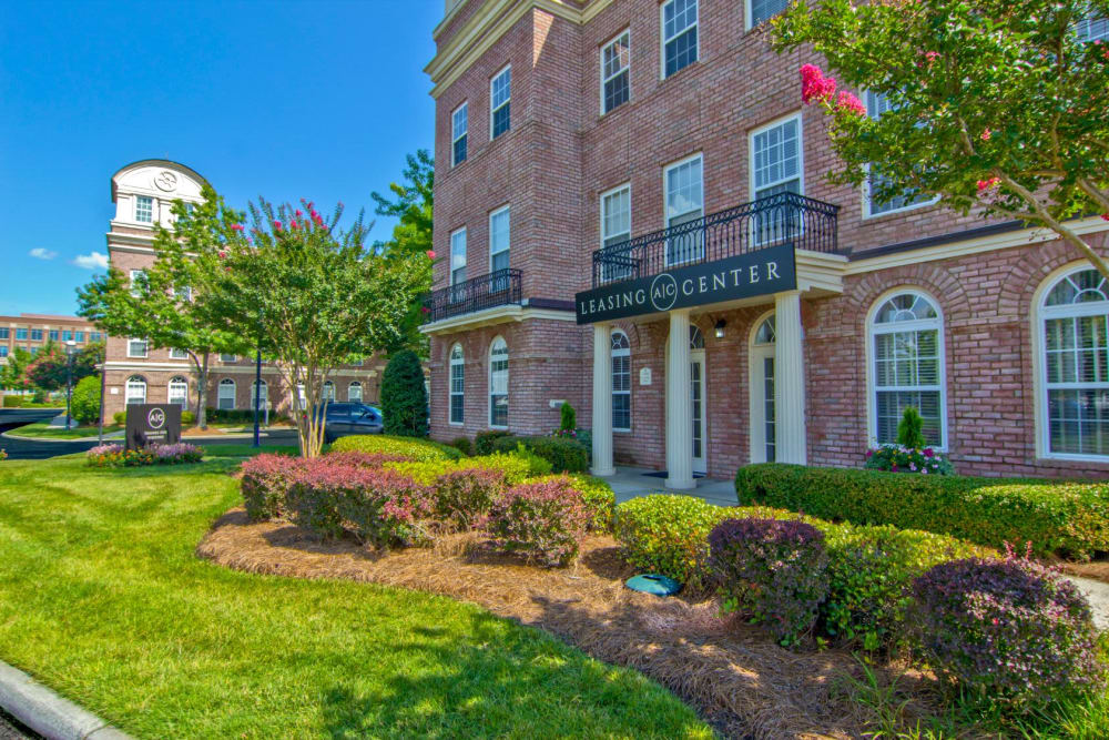 Pretty green lawn and plants on the side of Atkins Circle Apartments & Townhomes in Charlotte, North Carolina