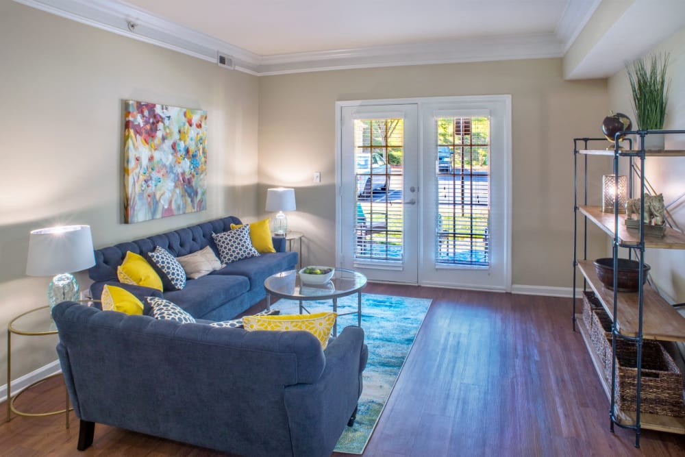 Living room staged nicely with wood style floors at Atkins Circle Apartments & Townhomes in Charlotte, North Carolina