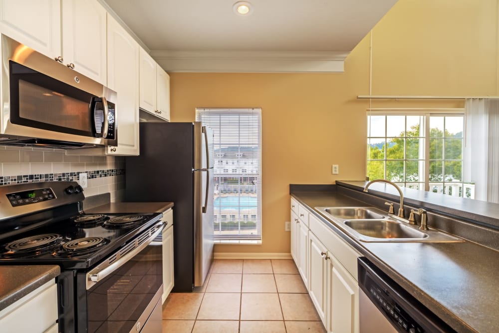 Kitchen with tile floors at The Waterfront Apartments & Townhomes in Munhall, Pennsylvania