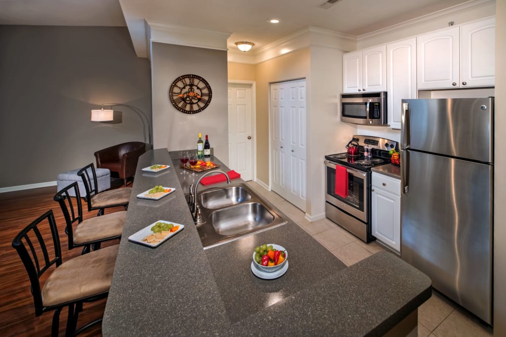 Contemporary kitchen with a breakfast bar at The Waterfront Apartments & Townhomes in Munhall, Pennsylvania