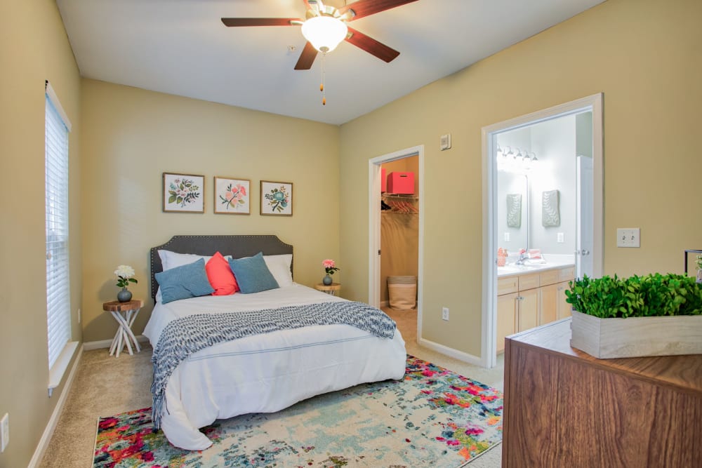 Bedroom with ceiling fan and walk in closet at Worthington Apartments & Townhomes in Charlotte, North Carolina