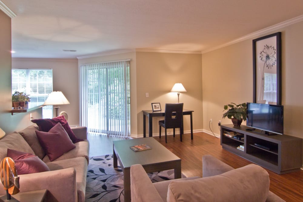 Living room with wood style flooring at The Woods at Polaris Parkway Apartments & Townhomes in Westerville, Ohio