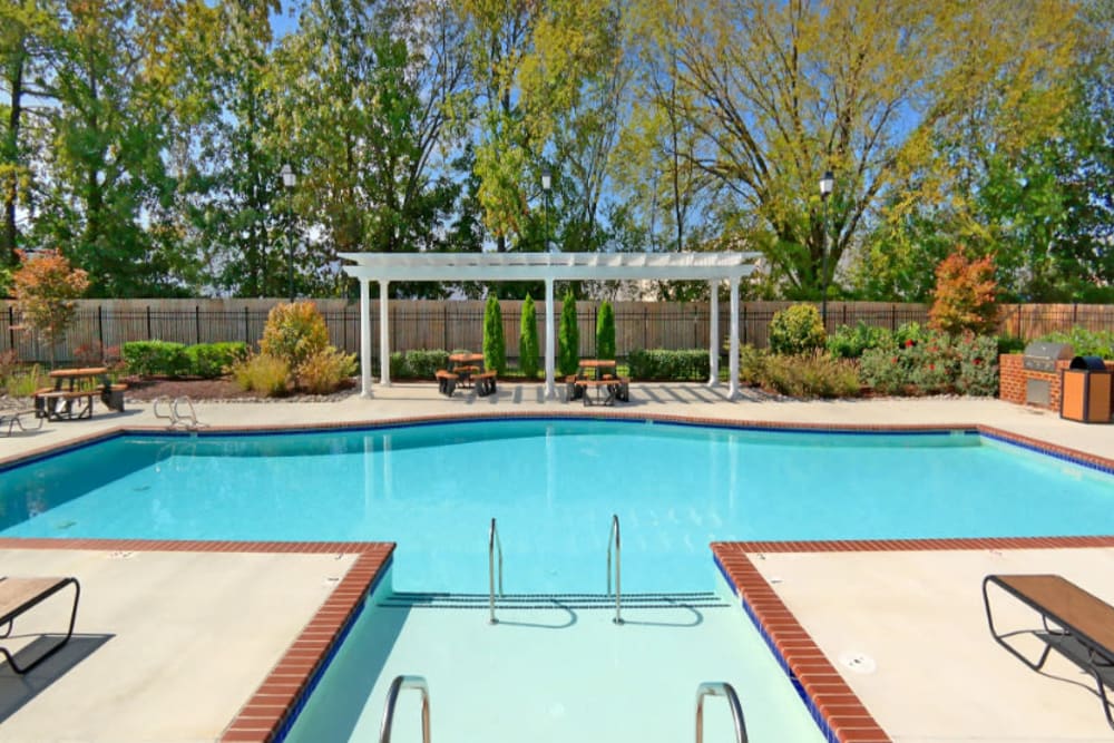 A swimming pool with an expansive sundeck at Meridian Watermark in North Chesterfield, Virginia