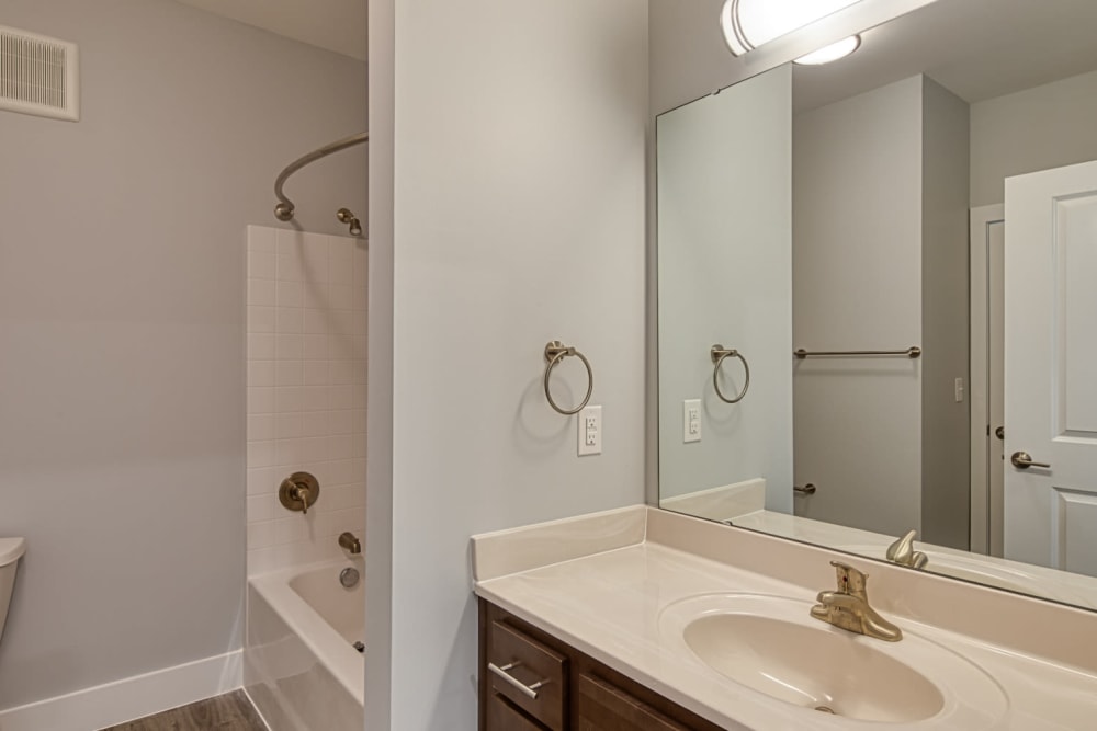 A bathroom with a large vanity mirror at Marina Villa in Norfolk, Virginia