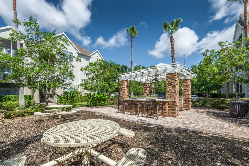 Big outdoor grilling area with tables at Eddison at Deerwood Park in Jacksonville, Florida