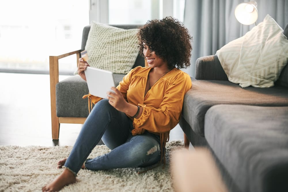Woman on her tablet in her living room at Mulberry Estates Apartments in Easton, Maryland