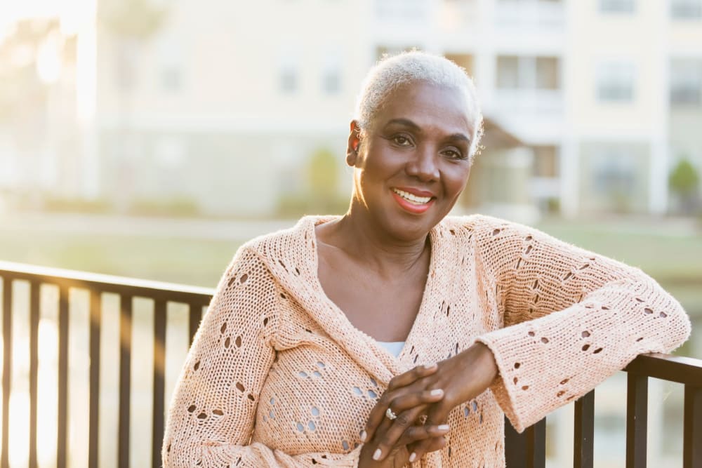 Woman on a balcony at Fairview Senior Apartments in Rising Sun, Maryland
