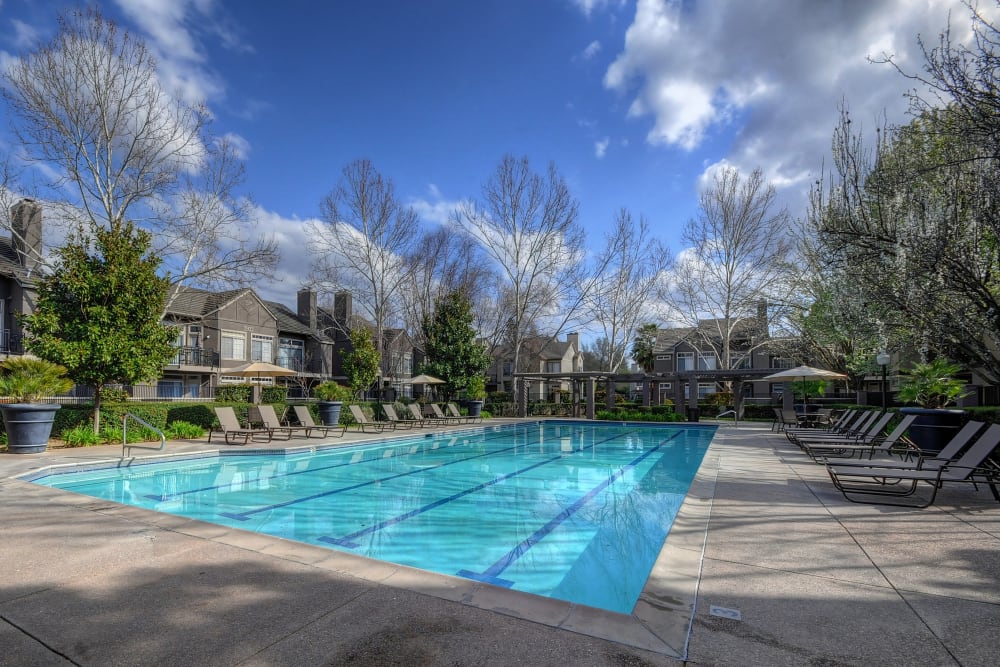 A poolside sundeck with plenty of lounge chairs at Larkspur Woods in Sacramento, California