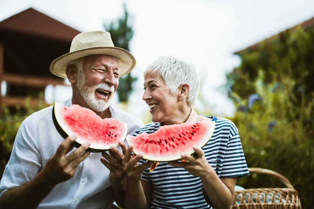 Happy couple enjoying watermelon in Hagerstown, Maryland near Hopewell Station Apartments
