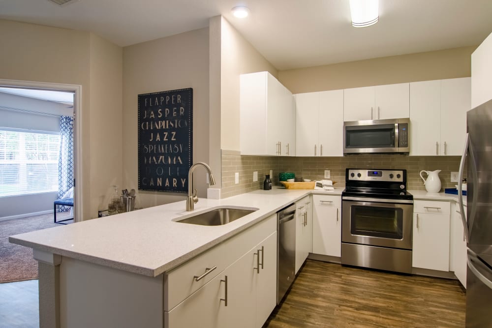 Kitchen with stainless steel appliances at Summit at Flatirons Apartments in Broomfield, Colorado